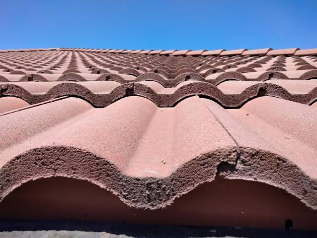 Close view showing the thick curved profile of concrete roof tile