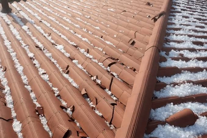 Clay or concrete tile roof with widespread hail impact breakage